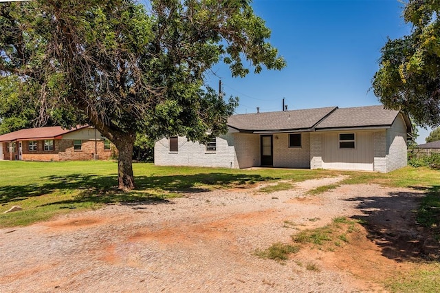 2120 E Robberts Ave, Kingfisher, OK 73750 - view of front of home with brick siding, a front yard, and driveway