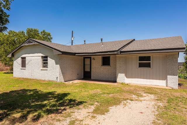 2120 E Robberts Ave, Kingfisher, OK 73750 - view of front of property with a shingled roof, a front lawn, and brick siding