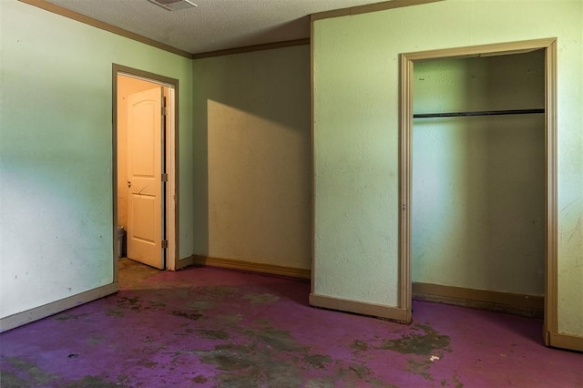 2120 E Robberts Ave, Kingfisher, OK 73750 - unfurnished bedroom featuring a closet, ornamental molding, and a textured ceiling