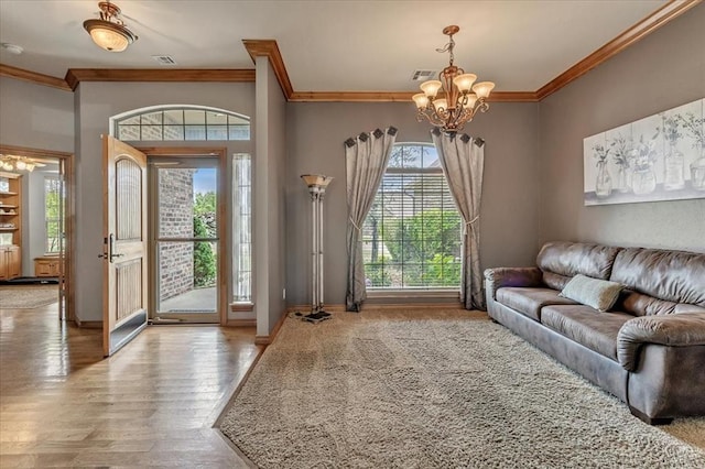 1716 NW 182nd St, Edmond, OK 73012 - living room featuring crown molding, a chandelier, and wood finished floors