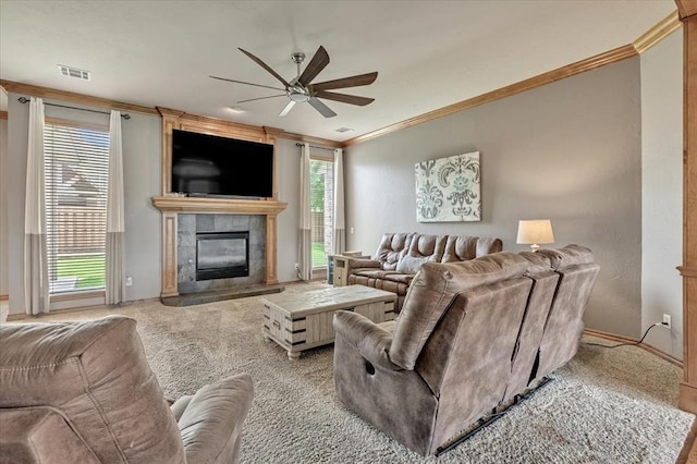 1716 NW 182nd St, Edmond, OK 73012 - carpeted living area featuring crown molding, ceiling fan, and a tiled fireplace