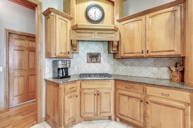 1716 NW 182nd St, Edmond, OK 73012 - kitchen with stone countertops, stainless steel gas stovetop, custom exhaust hood, decorative backsplash, and light tile patterned floors