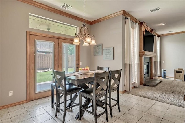 1716 NW 182nd St, Edmond, OK 73012 - dining area with crown molding, a fireplace, light tile patterned flooring, and a chandelier