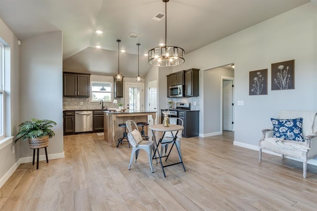 6420 SE 88th St, Oklahoma City, OK 73135 - dining area with light wood finished floors, a chandelier, and high vaulted ceiling
