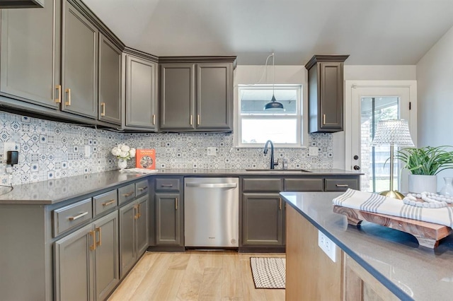 6420 SE 88th St, Oklahoma City, OK 73135 - kitchen with stainless steel dishwasher, light wood-style flooring, backsplash, gray cabinetry, and dark countertops