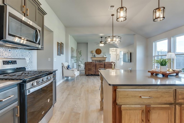6420 SE 88th St, Oklahoma City, OK 73135 - kitchen with stainless steel appliances, decorative backsplash, vaulted ceiling, decorative light fixtures, and open floor plan