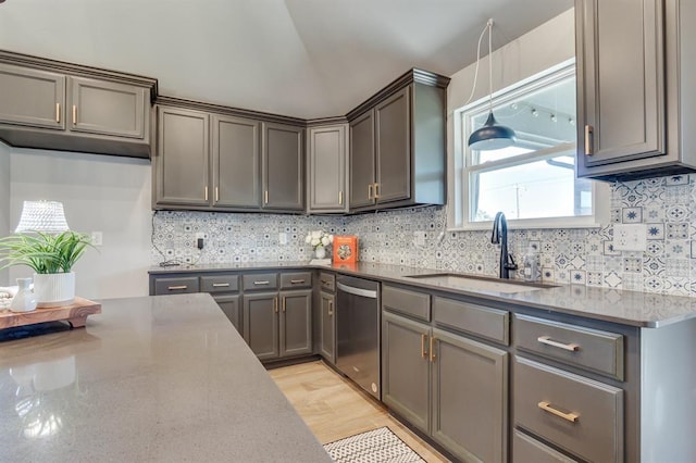 6420 SE 88th St, Oklahoma City, OK 73135 - kitchen featuring stainless steel dishwasher, decorative backsplash, stone countertops, hanging light fixtures, and light wood-style flooring