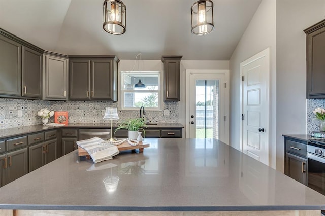 6420 SE 88th St, Oklahoma City, OK 73135 - kitchen featuring lofted ceiling, a spacious island, tasteful backsplash, and decorative light fixtures