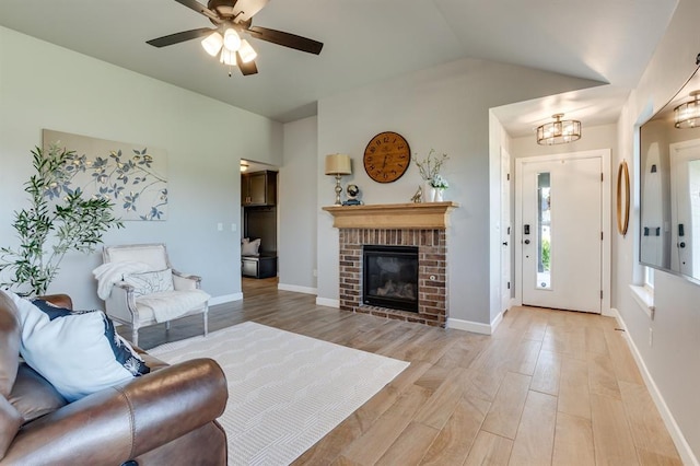 6420 SE 88th St, Oklahoma City, OK 73135 - living area with light wood finished floors, ceiling fan, a fireplace, vaulted ceiling, and a chandelier