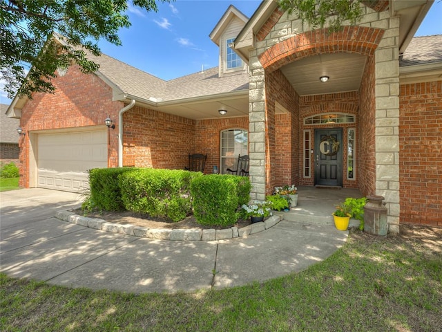 9021 NW 81st St, Yukon, OK 73099 - property entrance featuring brick siding, roof with shingles, an attached garage, and concrete driveway