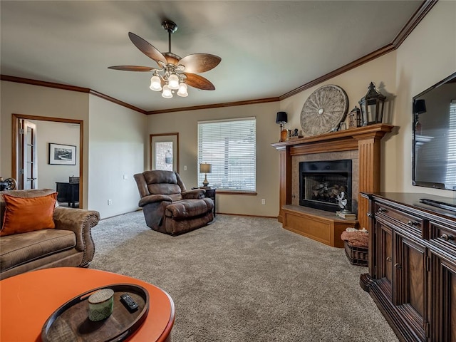 9021 NW 81st St, Yukon, OK 73099 - living area with carpet floors, a fireplace with raised hearth, ceiling fan, and crown molding