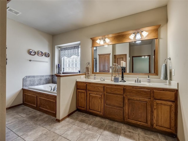 9021 NW 81st St, Yukon, OK 73099 - bathroom with double vanity, a garden tub, and tile patterned floors