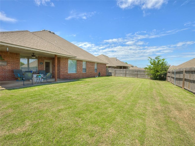 9021 NW 81st St, Yukon, OK 73099 - fenced backyard featuring a patio and a ceiling fan