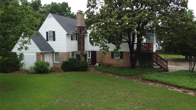 1712 W University Ave, Stillwater, OK 74074 - view of front of house with stone siding, a front lawn, a chimney, and stairs