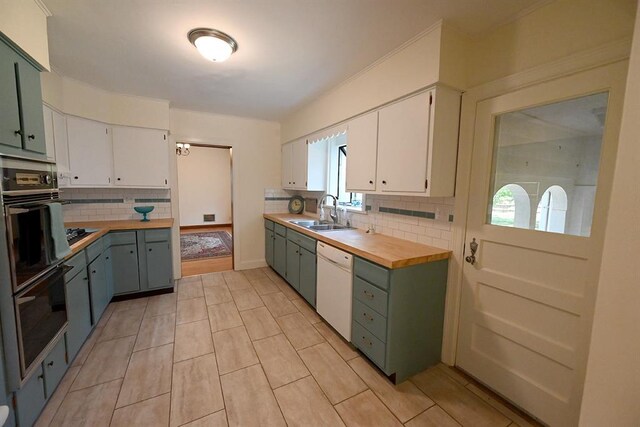 1712 W University Ave, Stillwater, OK 74074 - kitchen with black appliances, butcher block countertops, tasteful backsplash, and white cabinetry