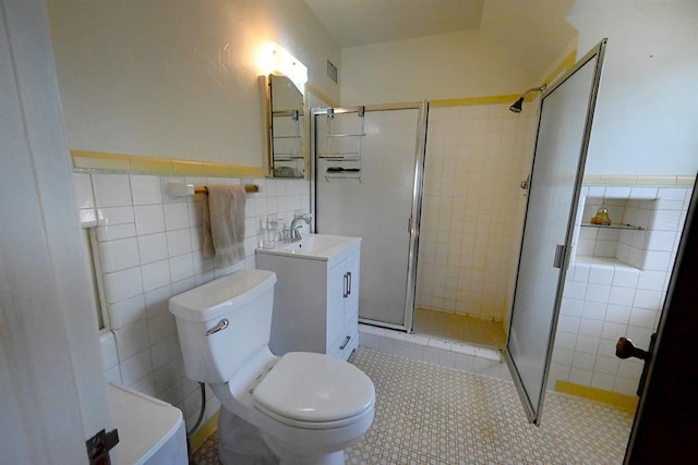 1712 W University Ave, Stillwater, OK 74074 - bathroom featuring tile walls, vanity, a stall shower, tile patterned floors, and wainscoting