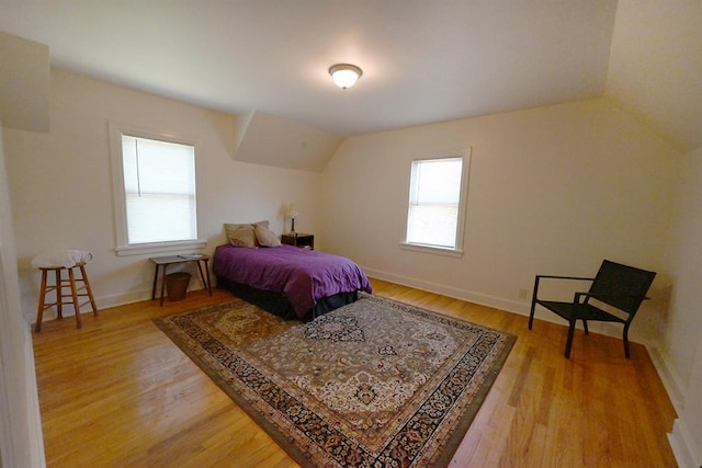 1712 W University Ave, Stillwater, OK 74074 - bedroom with light wood-style floors and lofted ceiling