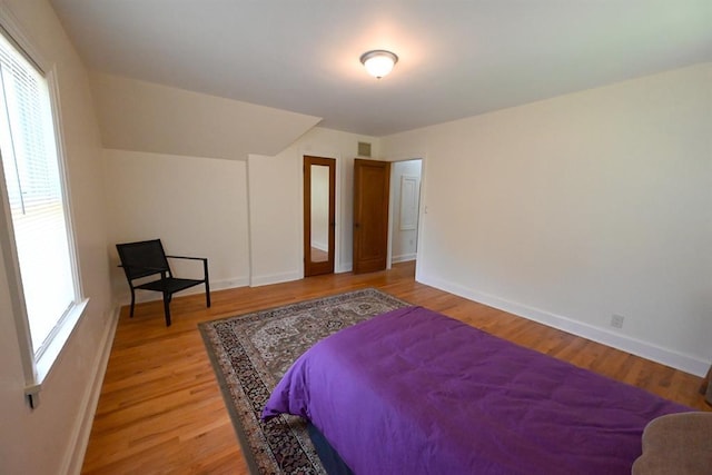 1712 W University Ave, Stillwater, OK 74074 - bedroom with light wood-style floors and baseboards