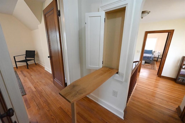 1712 W University Ave, Stillwater, OK 74074 - hallway featuring light wood-style flooring and arched walkways