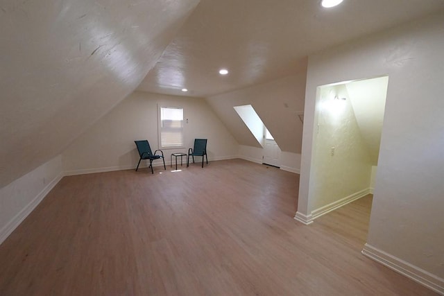 1712 W University Ave, Stillwater, OK 74074 - additional living space featuring wood finished floors, vaulted ceiling, and recessed lighting