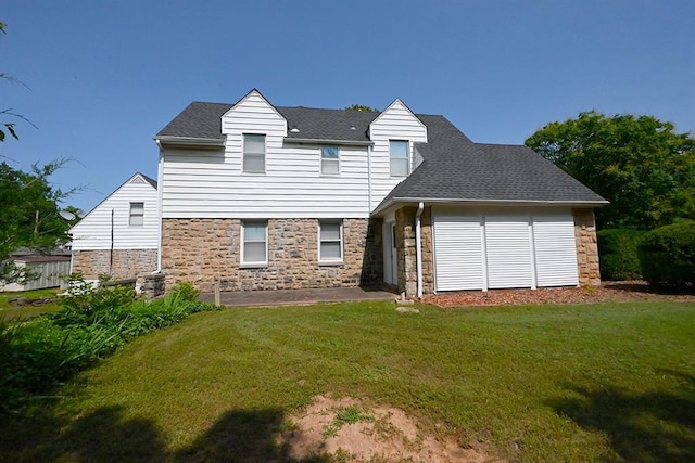 1712 W University Ave, Stillwater, OK 74074 - back of house with stone siding, a yard, and roof with shingles