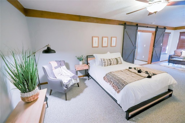 2202 NW 45th St, Oklahoma City, OK 73112 - bedroom featuring carpet floors, a barn door, and a ceiling fan