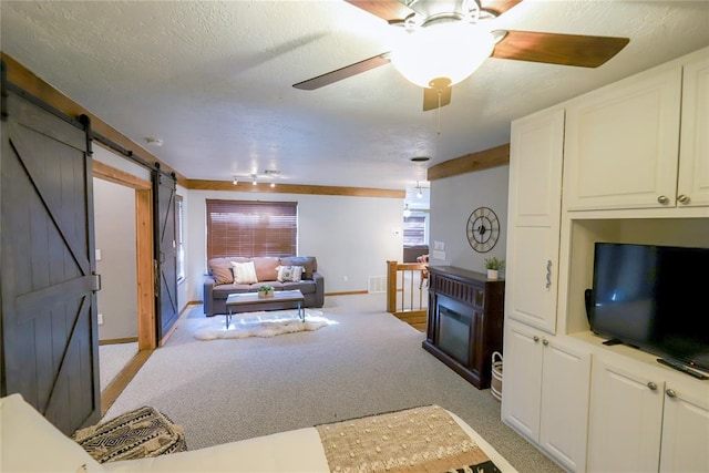 2202 NW 45th St, Oklahoma City, OK 73112 - living room featuring a barn door, light carpet, and ceiling fan