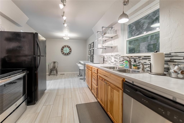 2202 NW 45th St, Oklahoma City, OK 73112 - kitchen featuring stainless steel appliances, light countertops, decorative backsplash, open shelves, and pendant lighting