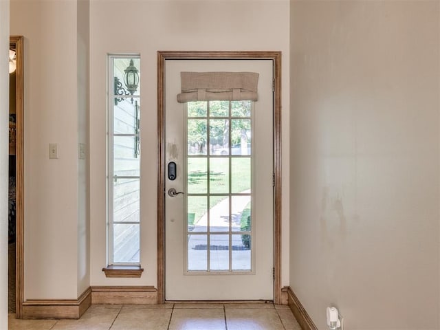 56201 E 285th Rd Unit F36, Afton, OK 74331 - doorway to outside featuring light tile patterned floors and baseboards