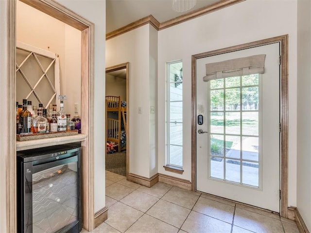 56201 E 285th Rd Unit F36, Afton, OK 74331 - entryway featuring wine cooler, a dry bar, light tile patterned floors, and crown molding