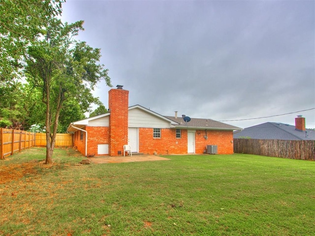 5901 Seminole Rd, Warr Acres, OK 73132 - rear view of house featuring a chimney, brick siding, a fenced backyard, and a patio area