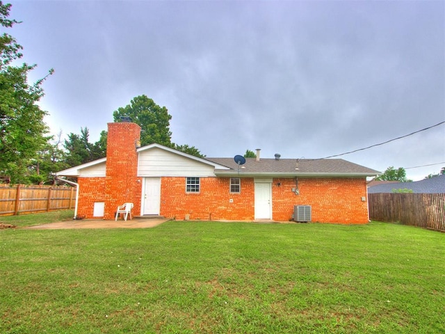 5901 Seminole Rd, Warr Acres, OK 73132 - back of house with a fenced backyard, a chimney, brick siding, and a patio area