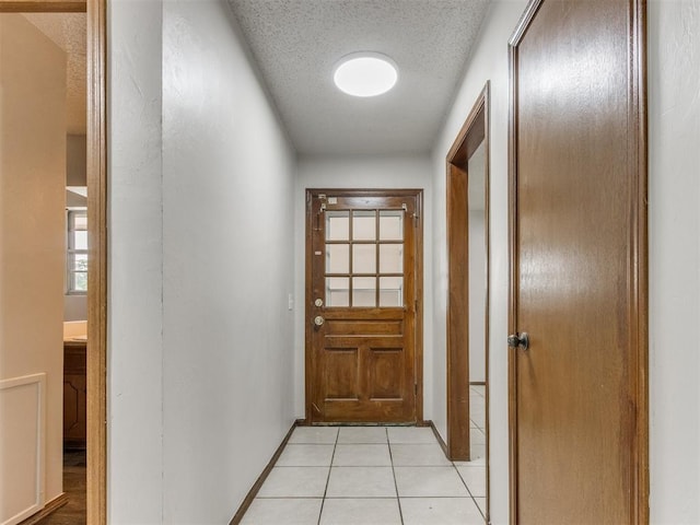 5901 Seminole Rd, Warr Acres, OK 73132 - doorway to outside featuring a textured ceiling and light tile patterned floors