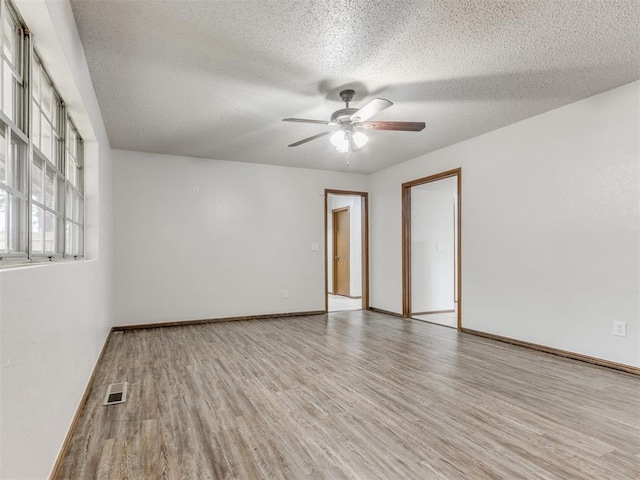5901 Seminole Rd, Warr Acres, OK 73132 - empty room featuring wood finished floors, ceiling fan, and a textured ceiling