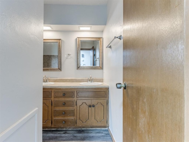 5901 Seminole Rd, Warr Acres, OK 73132 - bathroom featuring double vanity and wood finished floors