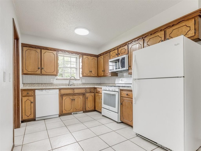 5901 Seminole Rd, Warr Acres, OK 73132 - kitchen with white appliances, brown cabinetry, light countertops, decorative backsplash, and a textured ceiling