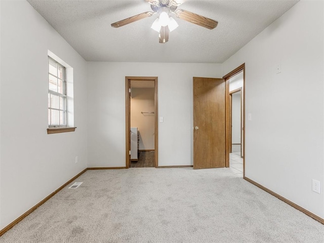 5901 Seminole Rd, Warr Acres, OK 73132 - unfurnished bedroom with a textured ceiling, carpet floors, and ceiling fan