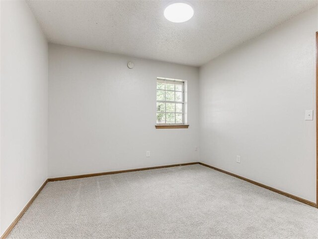 5901 Seminole Rd, Warr Acres, OK 73132 - empty room featuring carpet floors and a textured ceiling