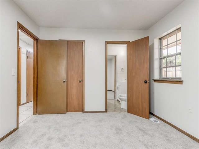 5901 Seminole Rd, Warr Acres, OK 73132 - unfurnished bedroom featuring carpet, ensuite bathroom, and a closet