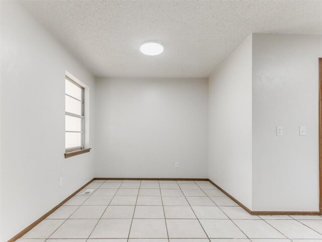 5901 Seminole Rd, Warr Acres, OK 73132 - unfurnished room with a textured ceiling and baseboards