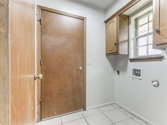 5901 Seminole Rd, Warr Acres, OK 73132 - laundry area with cabinet space, hookup for a washing machine, light tile patterned floors, and hookup for a gas dryer