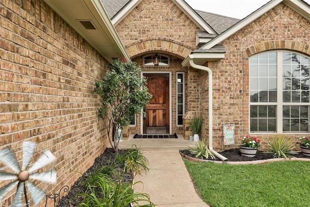 921 Tea Rose Dr, Yukon, OK 73099 - view of exterior entry with brick siding and roof with shingles