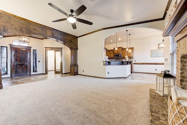 921 Tea Rose Dr, Yukon, OK 73099 - unfurnished living room with light colored carpet, ceiling fan, arched walkways, and crown molding