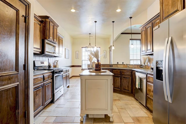 921 Tea Rose Dr, Yukon, OK 73099 - kitchen featuring stainless steel appliances, recessed lighting, plenty of natural light, decorative backsplash, and light countertops