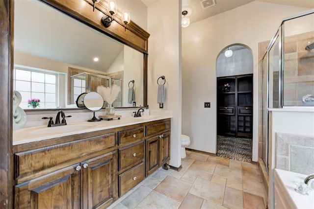 921 Tea Rose Dr, Yukon, OK 73099 - bathroom featuring a shower stall, double vanity, a bath, lofted ceiling, and stone finish floors
