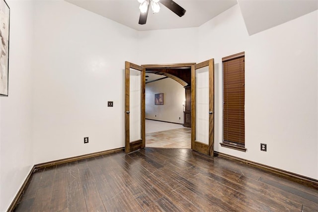 921 Tea Rose Dr, Yukon, OK 73099 - empty room with ceiling fan, wood finished floors, and arched walkways