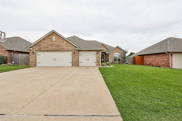 921 Tea Rose Dr, Yukon, OK 73099 - view of front of house featuring brick siding, driveway, and a garage