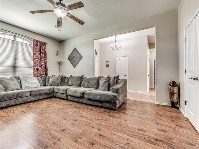 516 SW 161st St, Oklahoma City, OK 73170 - living room with a ceiling fan, a chandelier, and light wood-type flooring
