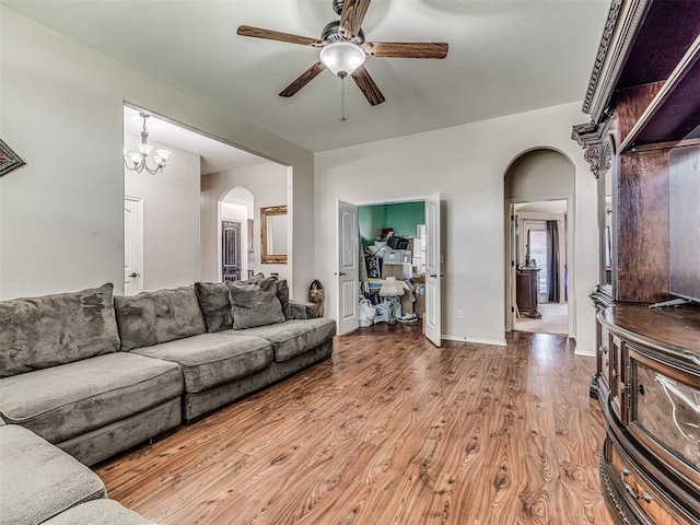 516 SW 161st St, Oklahoma City, OK 73170 - living room with arched walkways, a ceiling fan, and wood finished floors