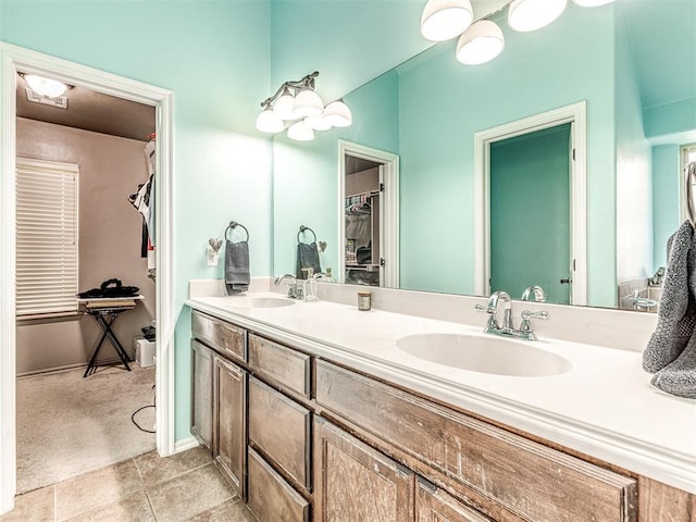 516 SW 161st St, Oklahoma City, OK 73170 - bathroom featuring double vanity, a walk in closet, and tile patterned floors